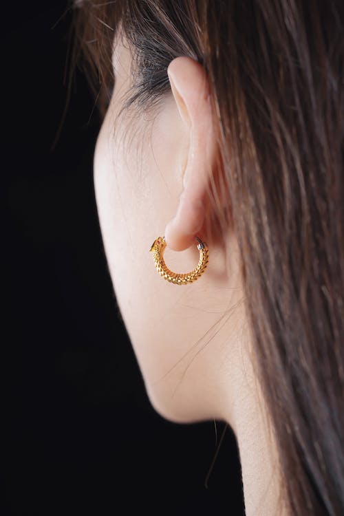 Brunette Woman Wearing Gold Earring