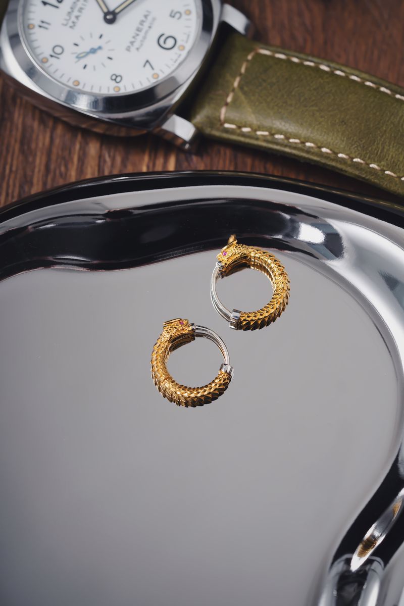 Gold and silver precious gifting pieces on a reflective tray