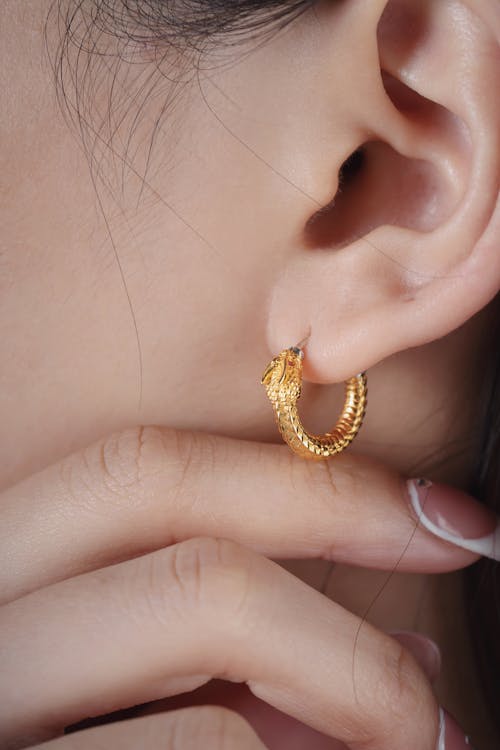 Brunette Woman Wearing Gold Earring