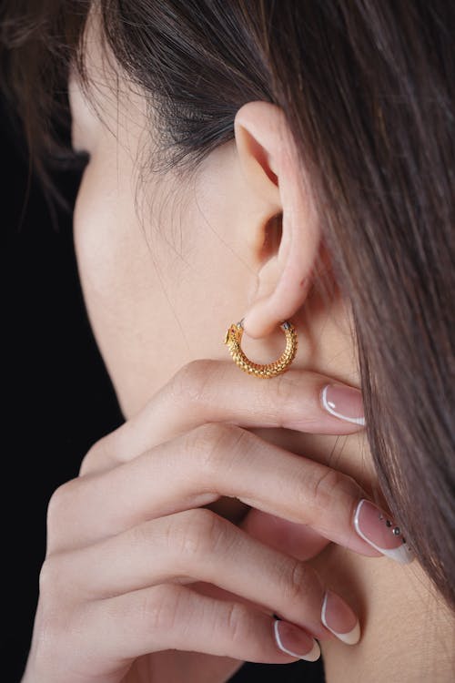 Brunette Woman Wearing Gold Earrings