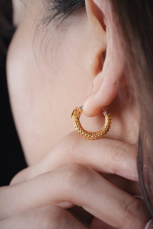 Brunette Woman Wearing Gold Earring