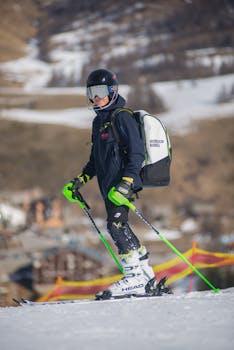Skier carving down Telluride's groomed run with sunlit peaks behind