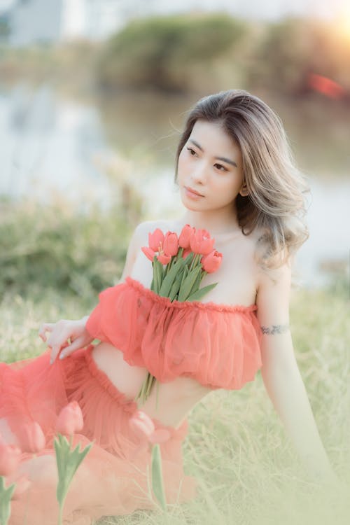 Woman Sitting and Posing with Tulips