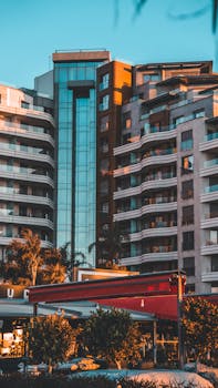 Contemporary skyscrapers basking in warm sunset hues, creating an urban cityscape.
