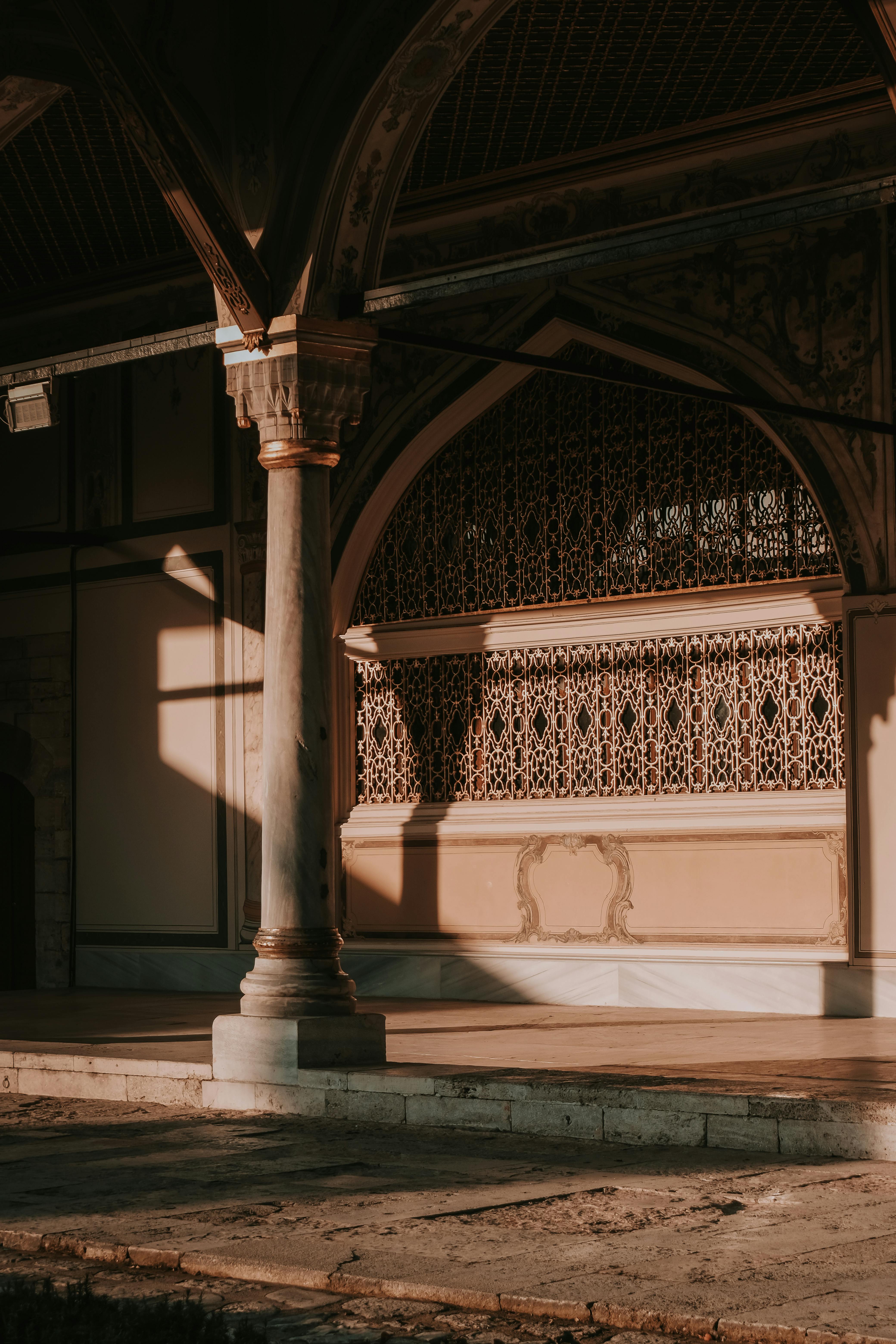 a photo of an arched doorway with a sun shining on it