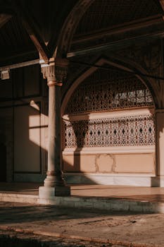 Intricate architectural details in warm light, showcasing elegant arches and columns.