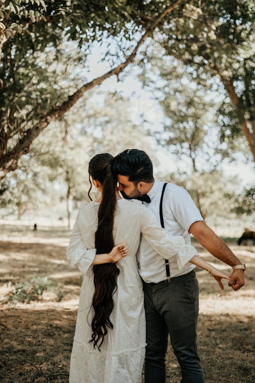 Bride and Groom Hugging in a Park 