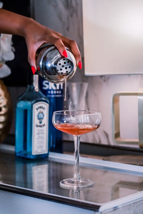 Free Close-up of a Woman Pouring a Drink into a Glass Stock Photo