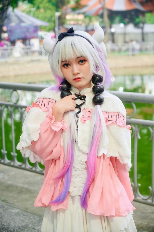 Free Striking portrait of a cosplayer in a unique and colorful costume outdoors. Stock Photo
