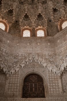 Detailed ornamentation inside the Alhambra Palace in Granada, showcasing Moorish architecture.
