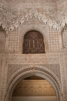Ornate architectural archway with detailed patterns in a historic building interior.