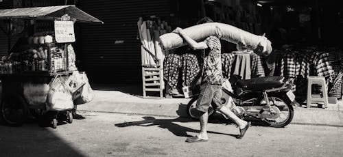 Man Carrying Wares on Bazaar