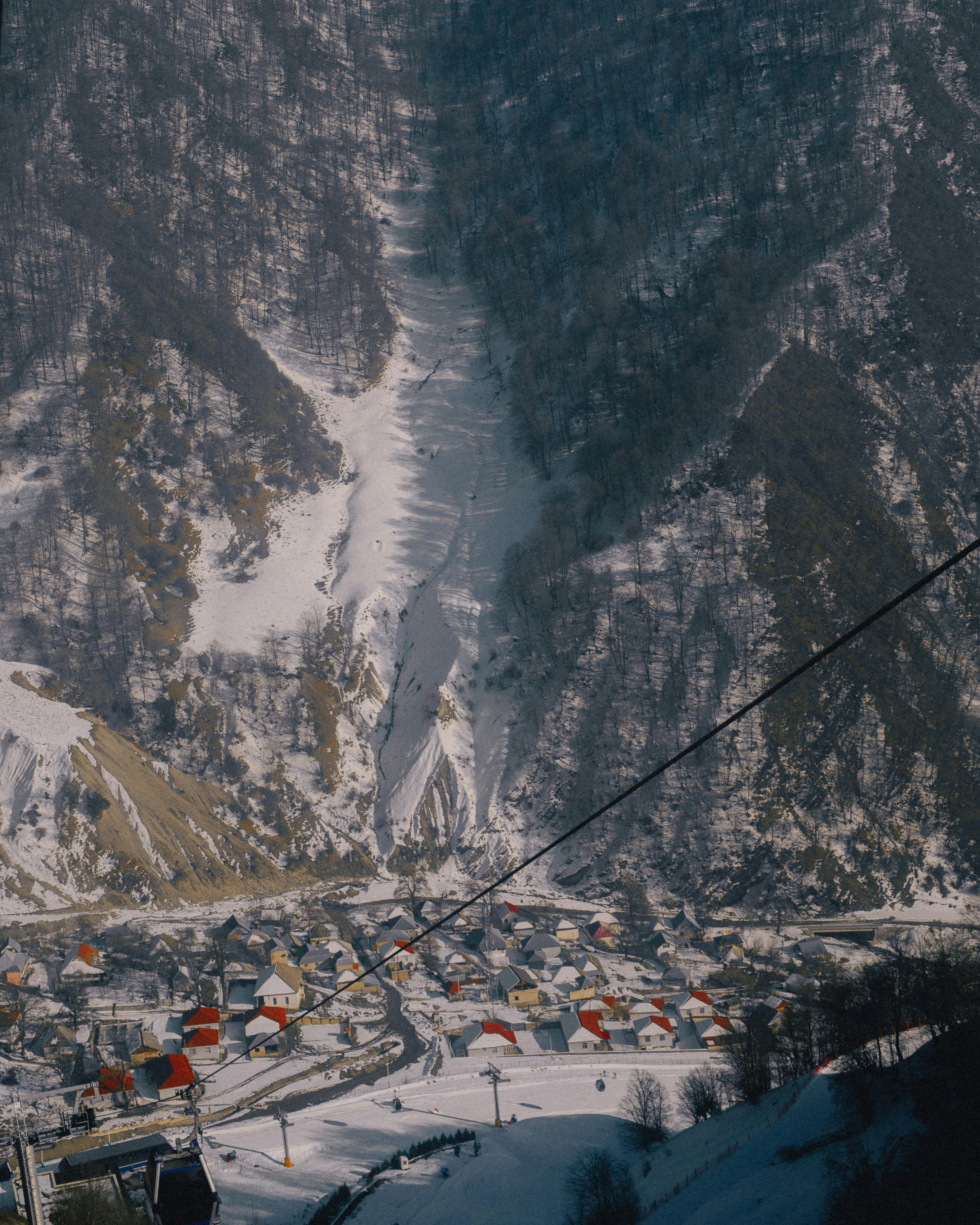A picturesque winter view of a village nestled in the snowy mountains of Gebele, Azerbaijan.