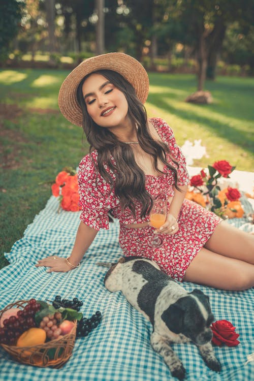 Portrait of a Young Woman Relaxing on a Picnic Blanket with a Dog