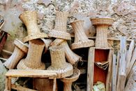 Brown Wicker Baskets and Brown Wooden Stool Beside Concrete Wall