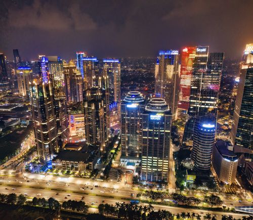 Free A vibrant night skyline of Jakarta, showcasing illuminated skyscrapers and bustling urban life. Stock Photo