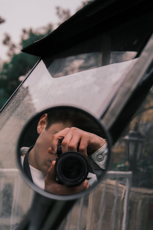 Man Taking Picture with Camera in Mirror