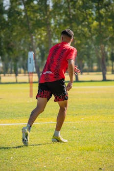 A young soccer player in action on a sunny day at a field in Mendoza, Argentina.