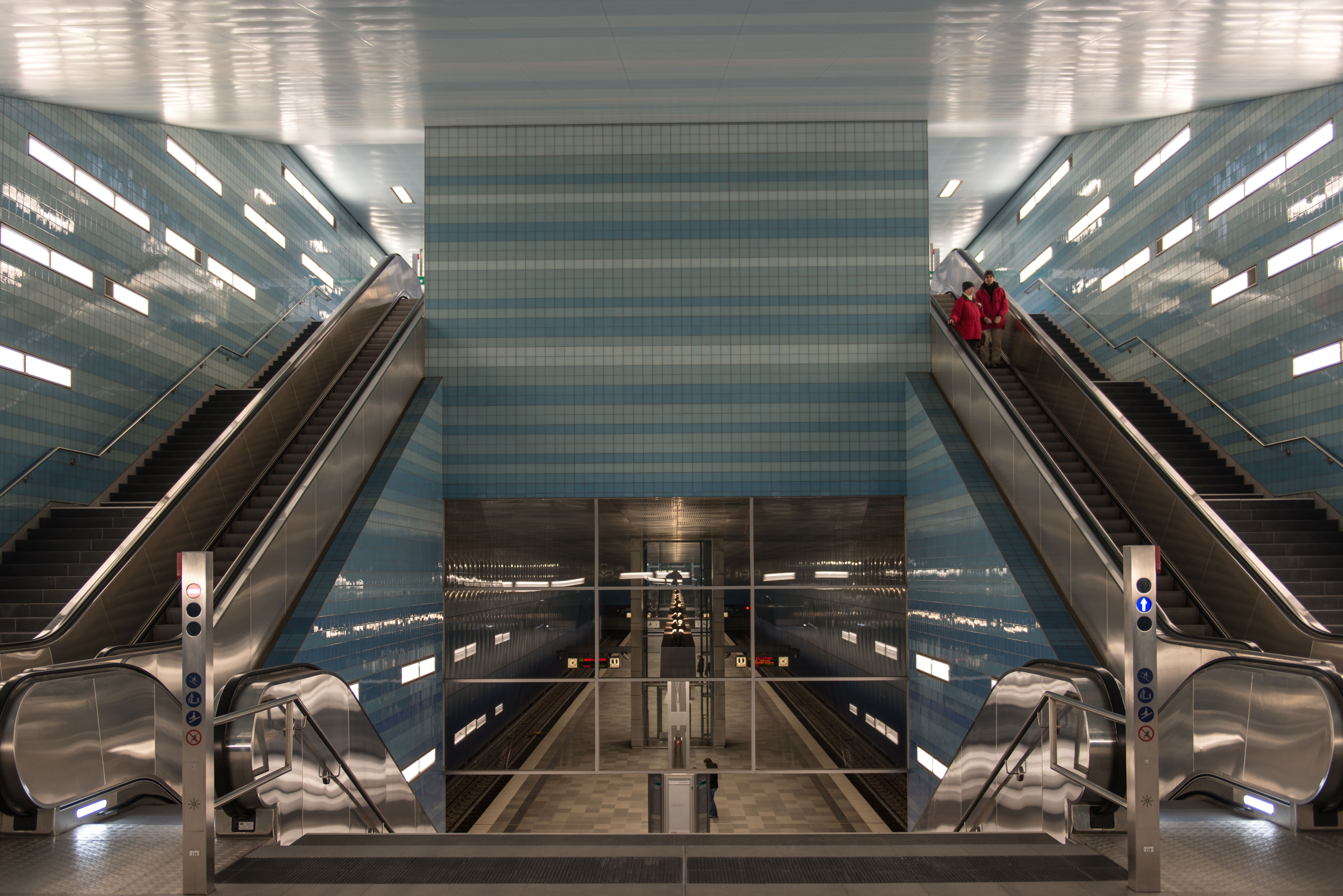 Interior view of Überseequartier subway station in Hamburg with modern escalators.