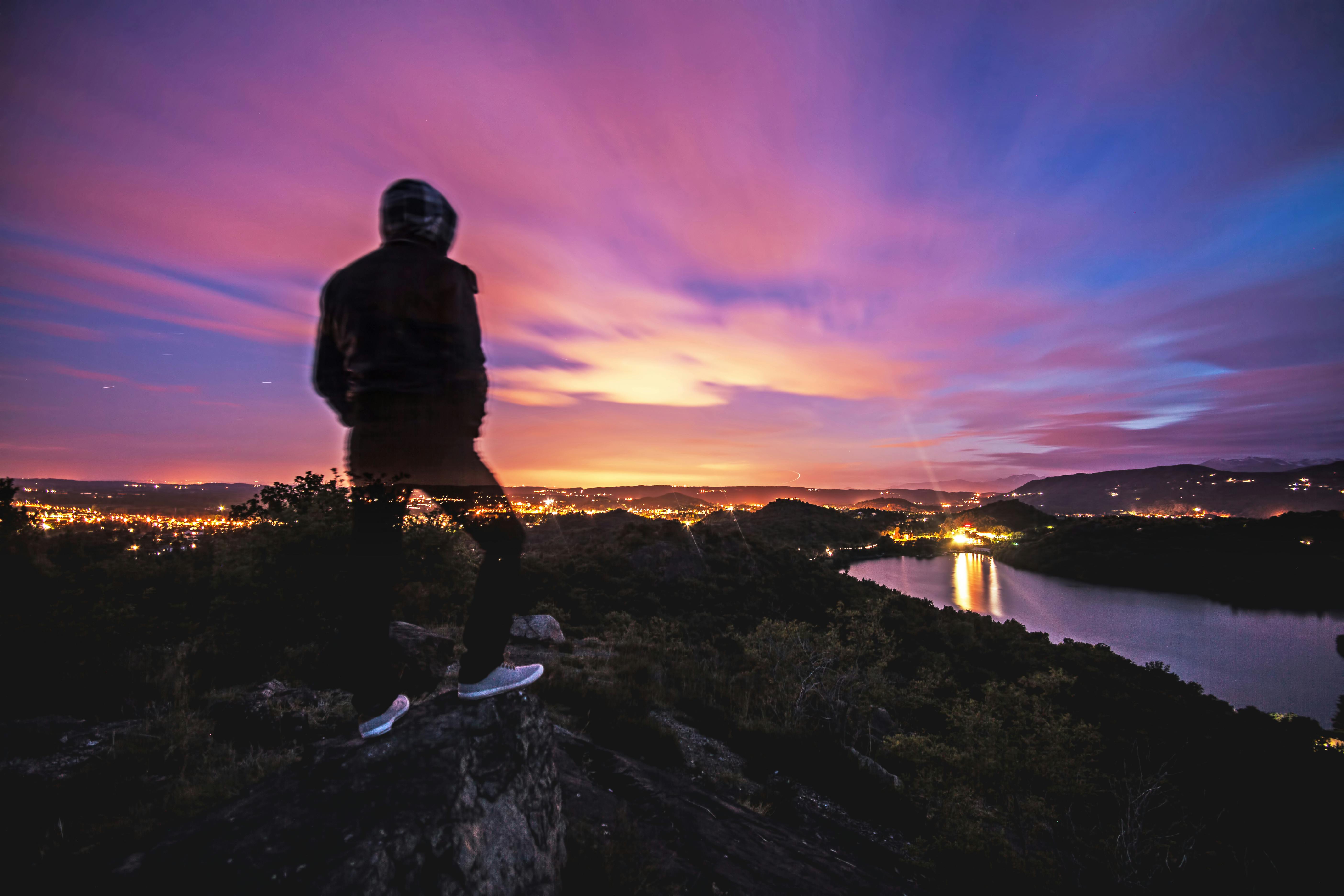 Man In Black Jacket Standing On Rocky Ground Free Stock Photo