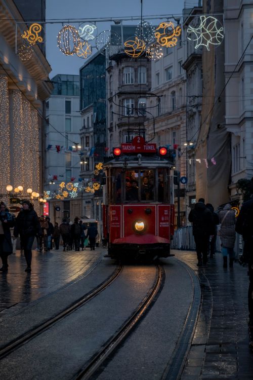 Free Atmospheric city street at night with holiday lights and tram in Istanbul. Stock Photo