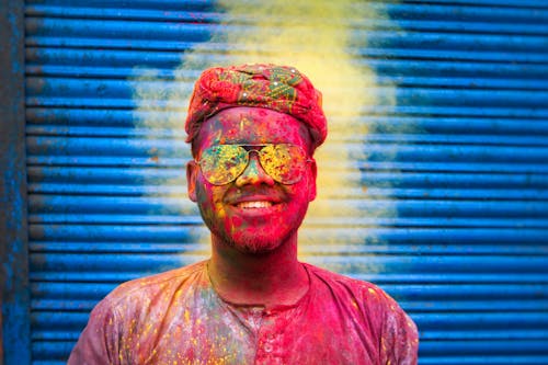 Happy Man Covered in Colorful Powder at Holi Festival