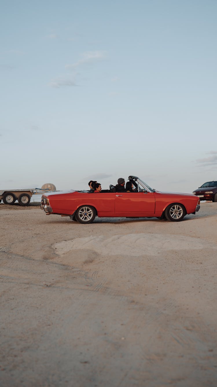 People In Vintage Car On Desert