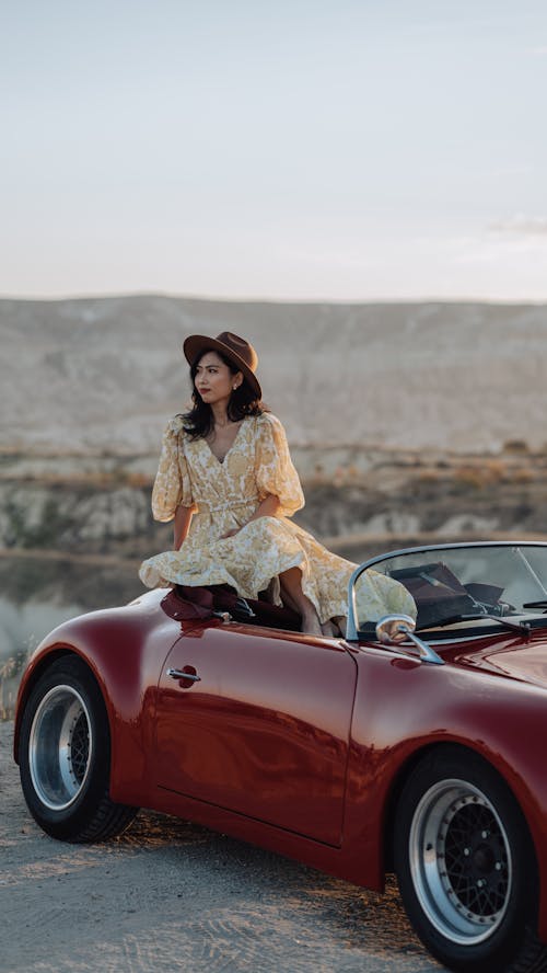 Woman in Vintage Car Wearing Dress