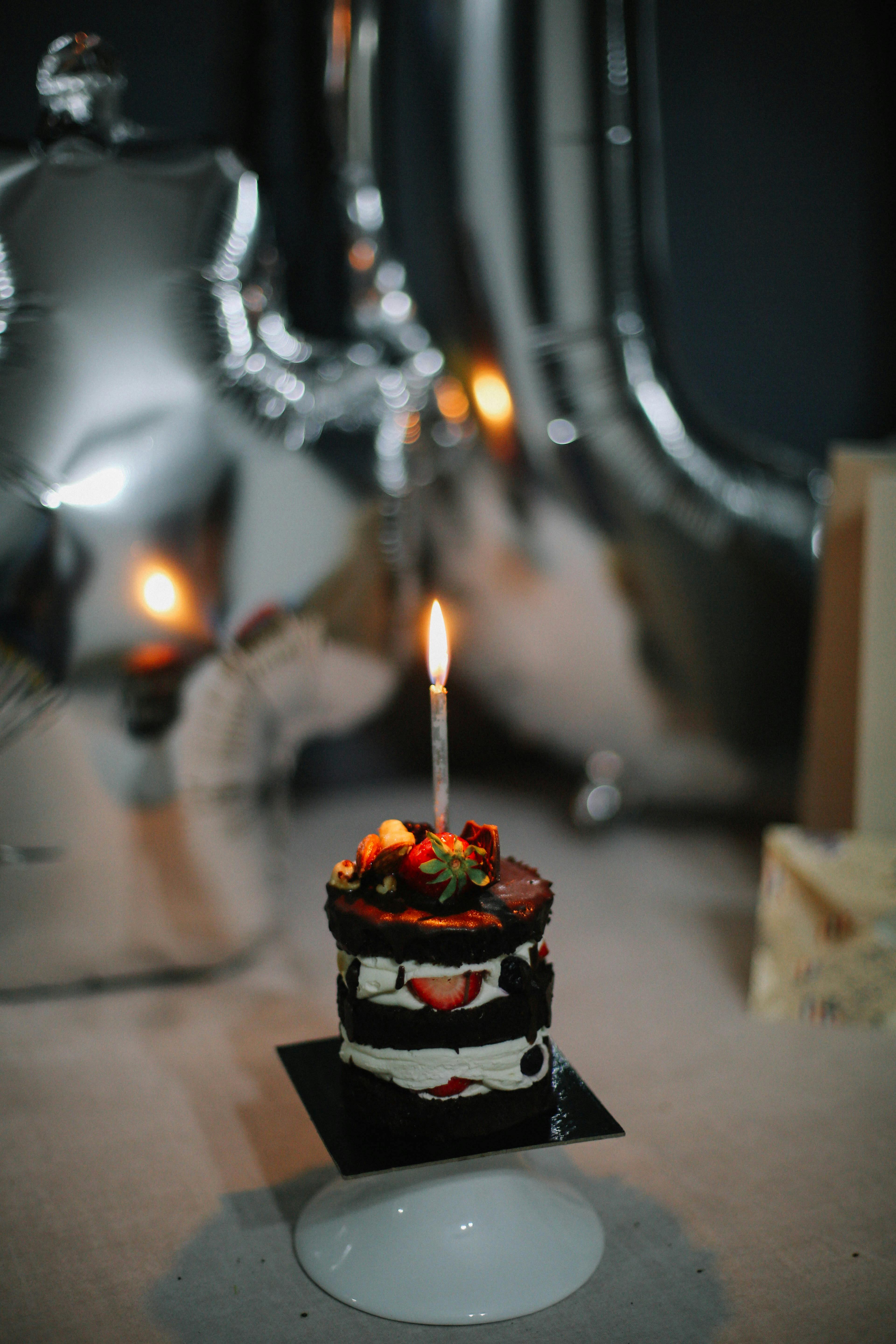 Free Photo | Chocolate birthday cake with burning candles and decorations  generative ai