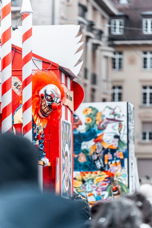 Free Vibrant clown carnival display in bustling city festival setting, capturing lively urban atmosphere. Stock Photo