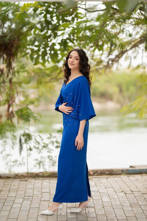 Woman in a Blue Dress and White High Heels