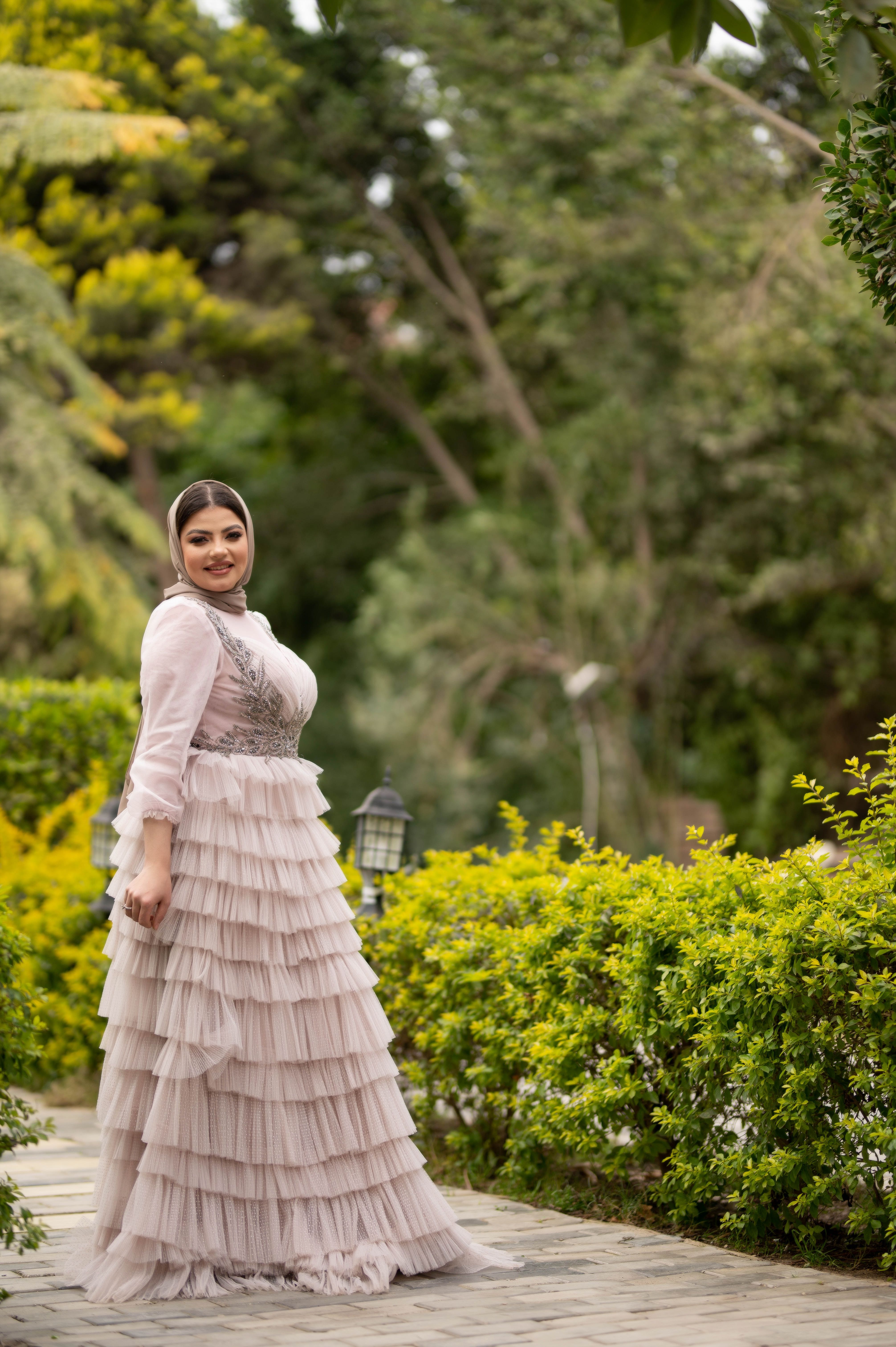 Woman in Hijab and White Dress Posing in Garden · Free Stock Photo