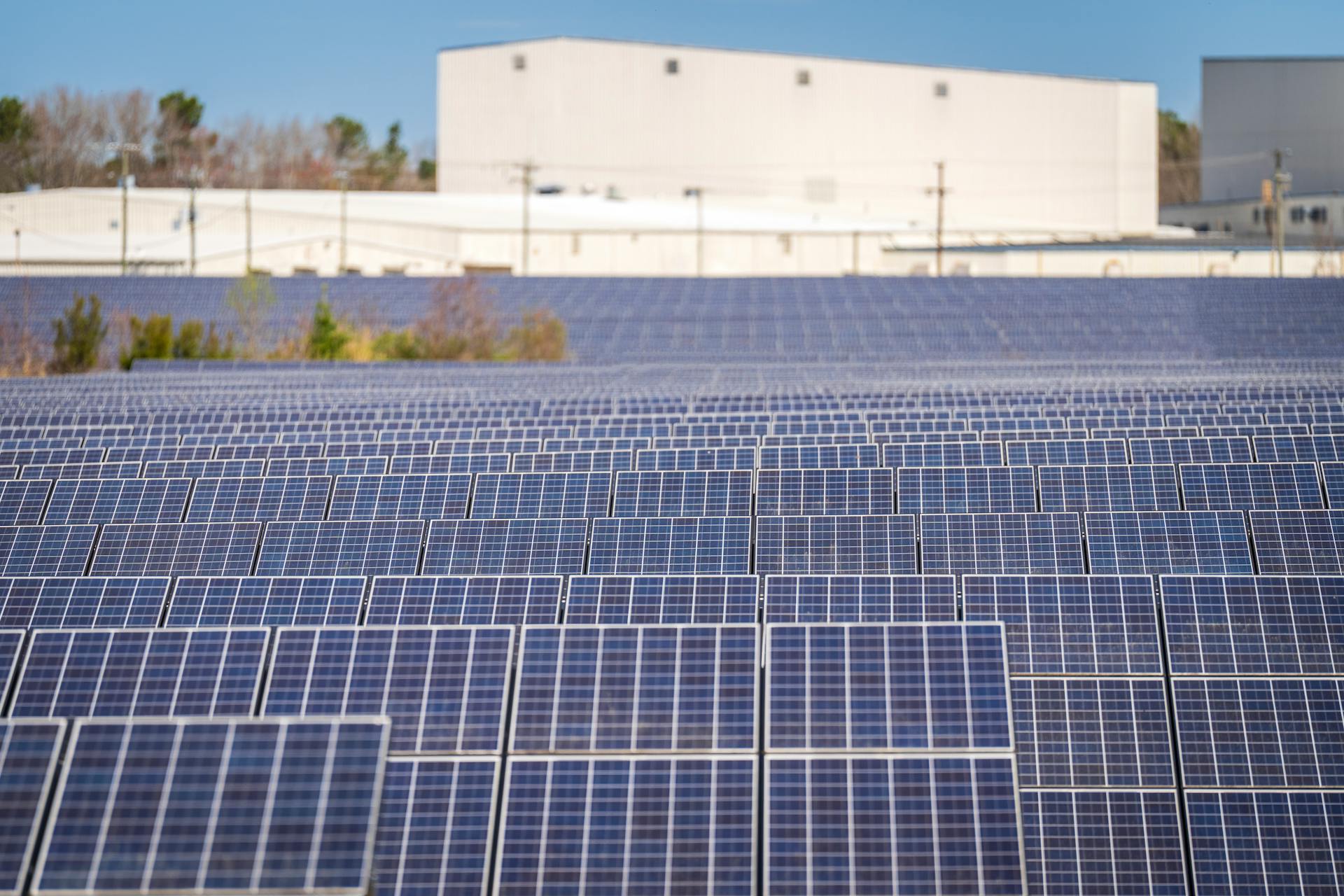 A large solar farm with photovoltaic panels generating renewable energy outdoors.