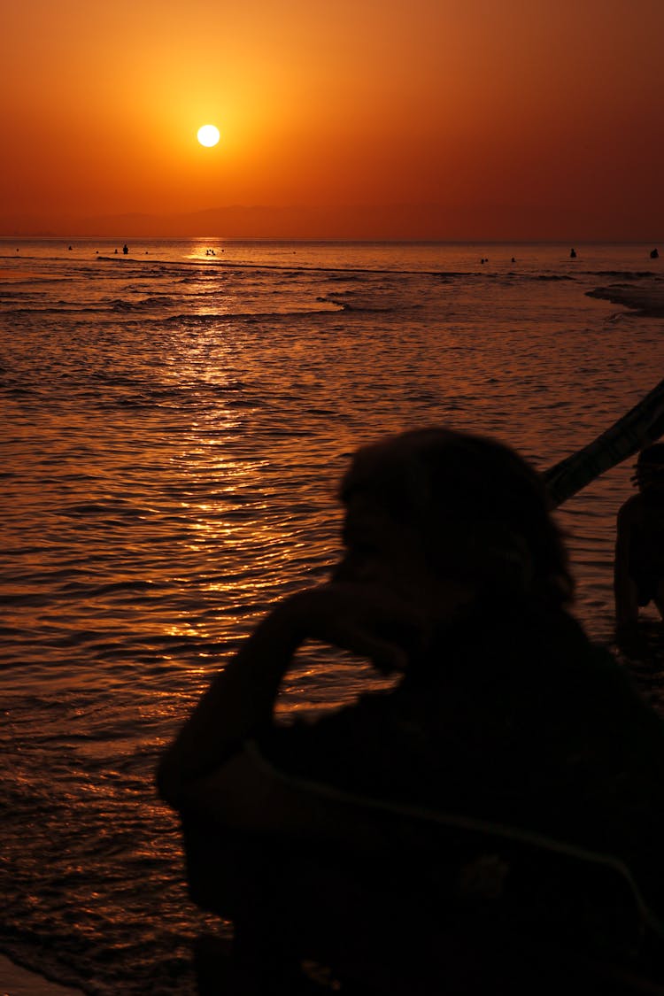 Head Silhouette At Sunset On Shore