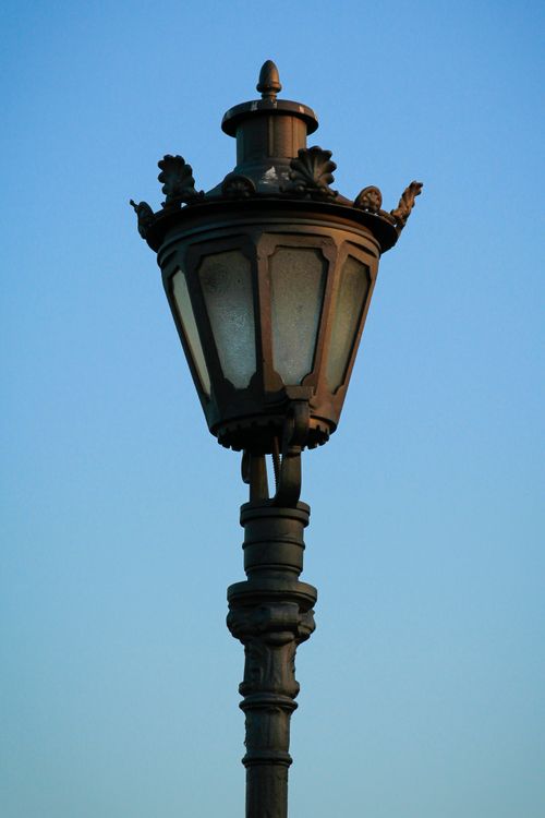 Free A classic street lamp photographed against a clear blue sky, showcasing timeless elegance. Stock Photo