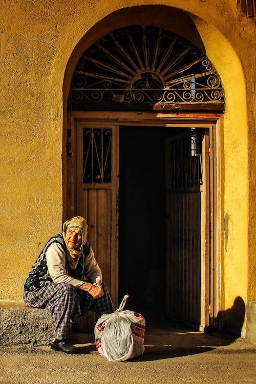 A Woman Sitting by a Door 