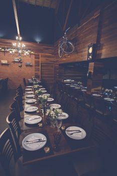 Charming rustic dining setup in a wooden interior ideal for special occasions or receptions.