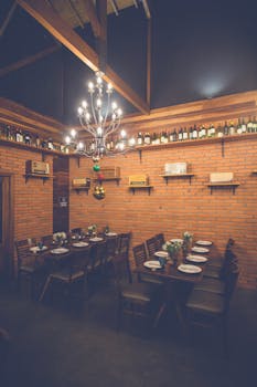 Charming restaurant interior featuring a rustic design with a chandelier and brick walls set for dining.
