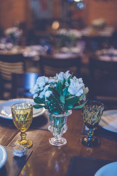 Free A sophisticated table setting featuring a floral centerpiece with decorative glassware, ideal for elegant dining occasions. Stock Photo