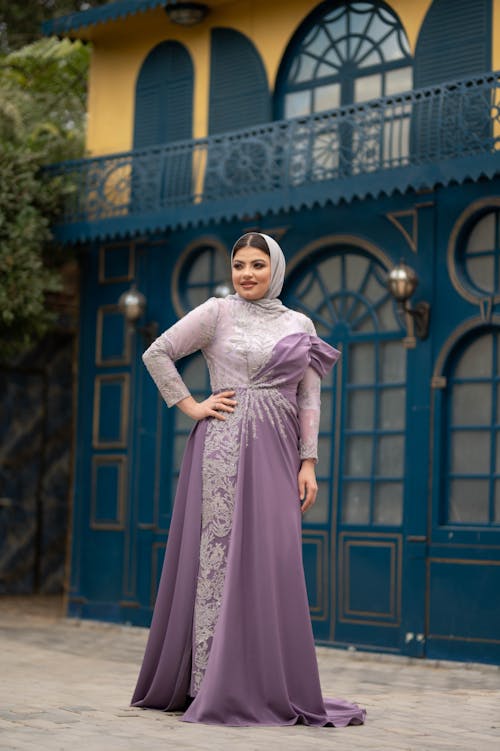 Woman Wearing an Elegant Purple Dress and a Hijab