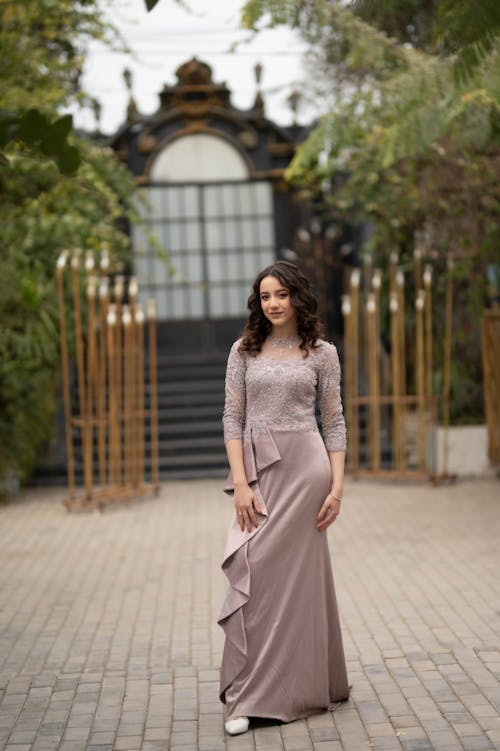 Young Brunette in an Elegant Dress Posing Outdoors 