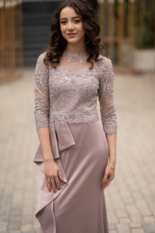 Young Brunette in an Elegant Dress Posing Outdoors 