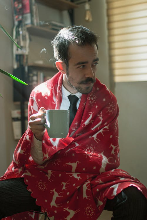 Sitting Man Holding a Mug