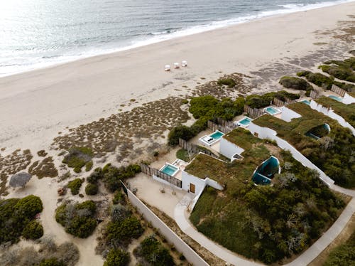 Aerial View of Houses with Pools on the Beach 