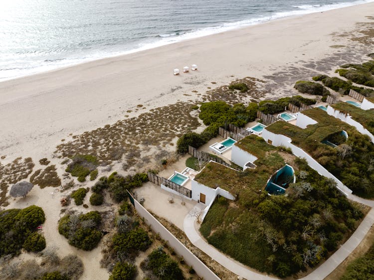 Aerial View Of Houses With Pools On The Beach 