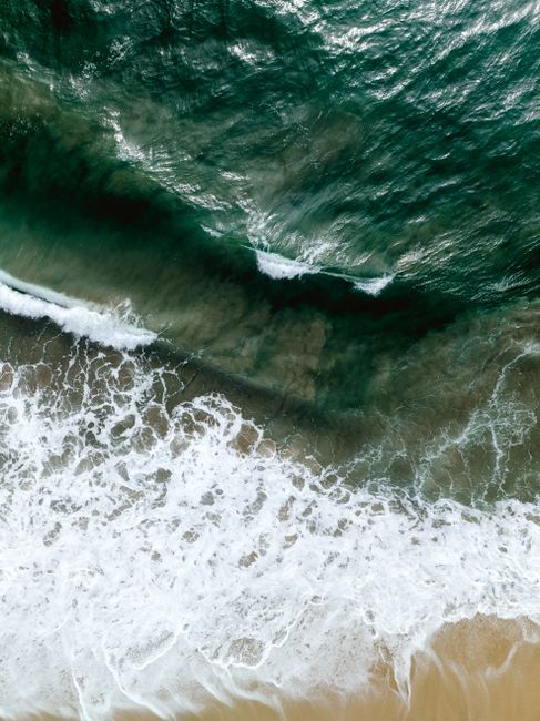 Aerial shot of Casa Cyrene's coast in Mexico, showcasing vibrant waves and serene shorelines.