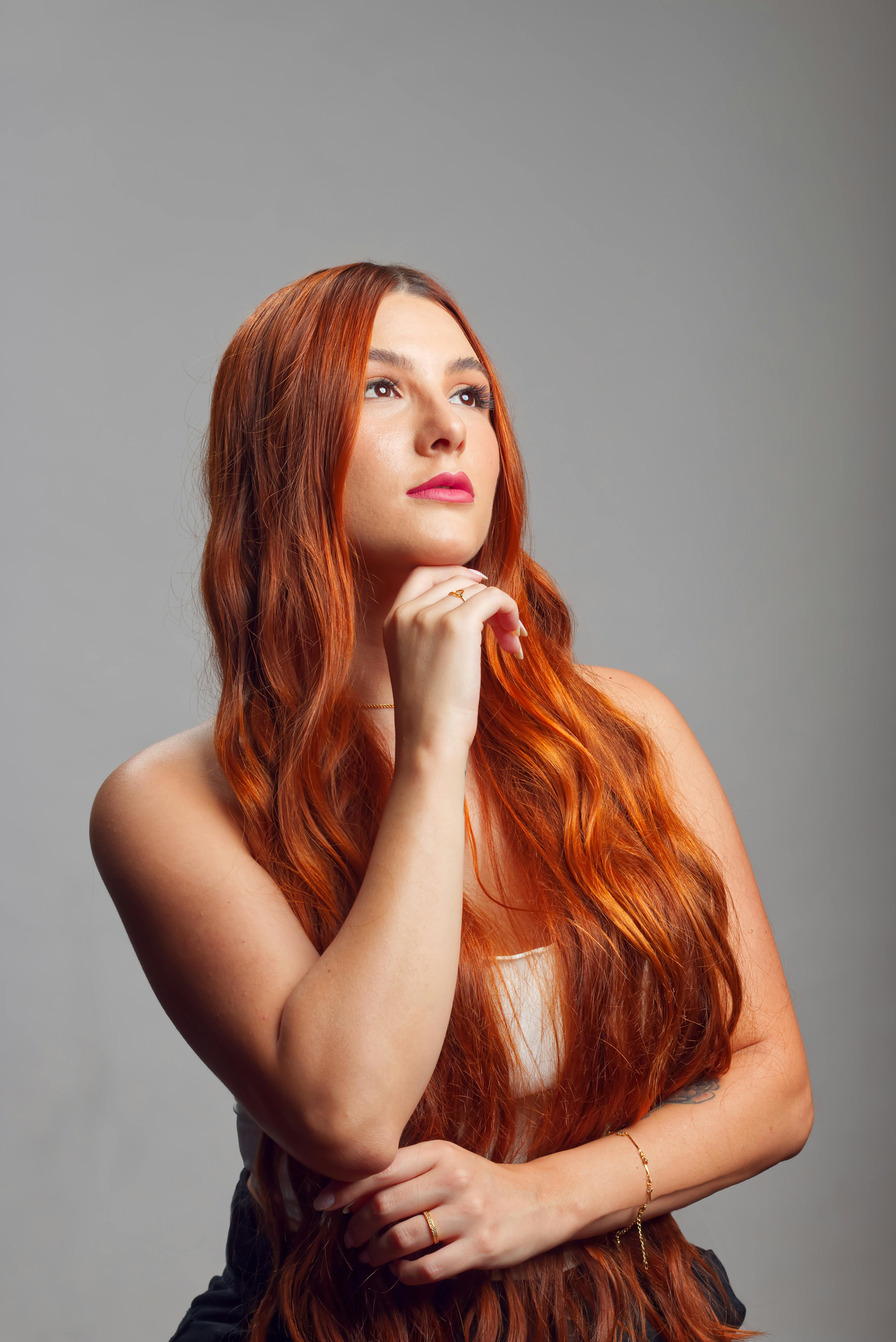 Beautiful Red Haired Woman with Hand on Chin · Free Stock Photo