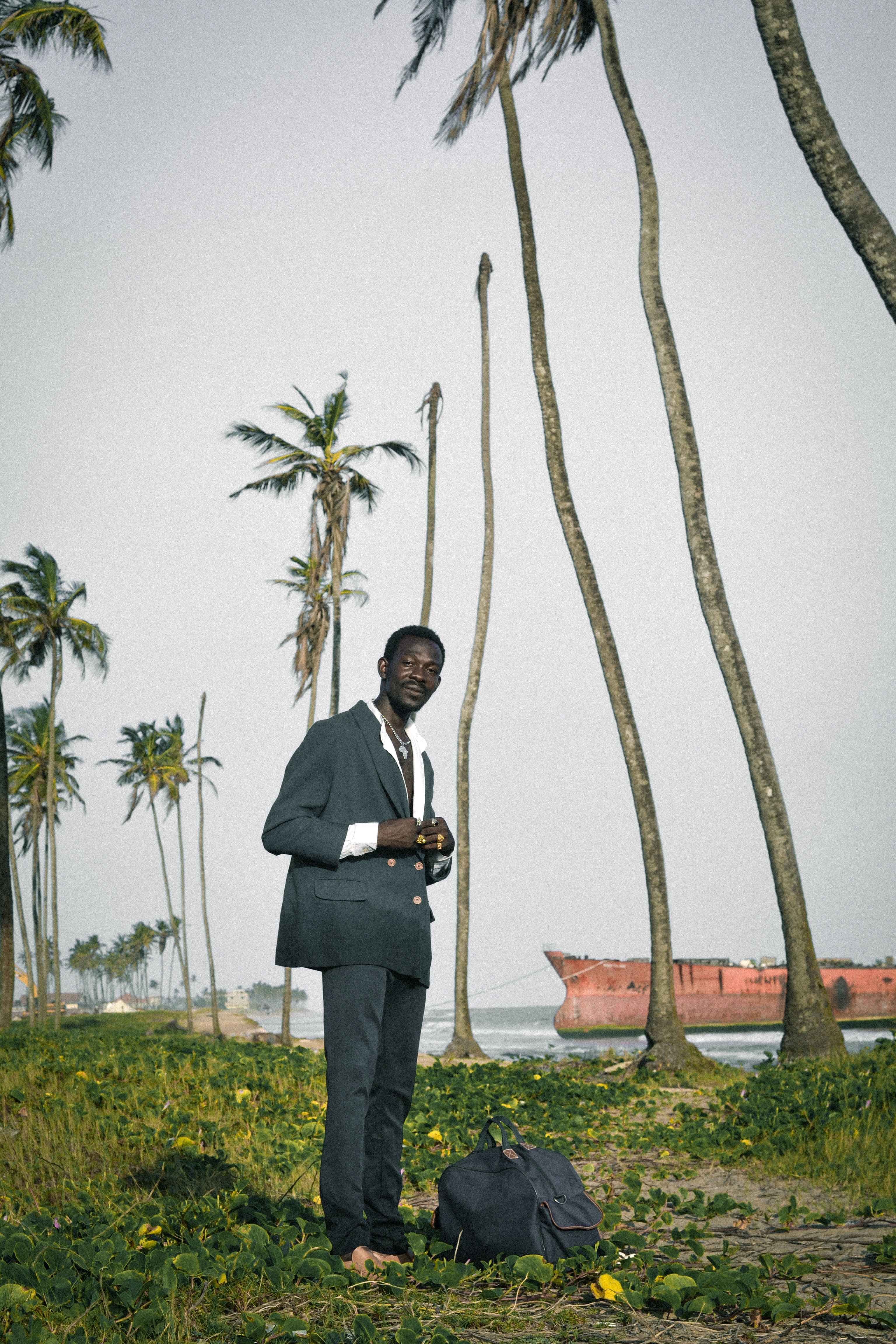 Man in Suit Standing Among Palm Trees · Free Stock Photo