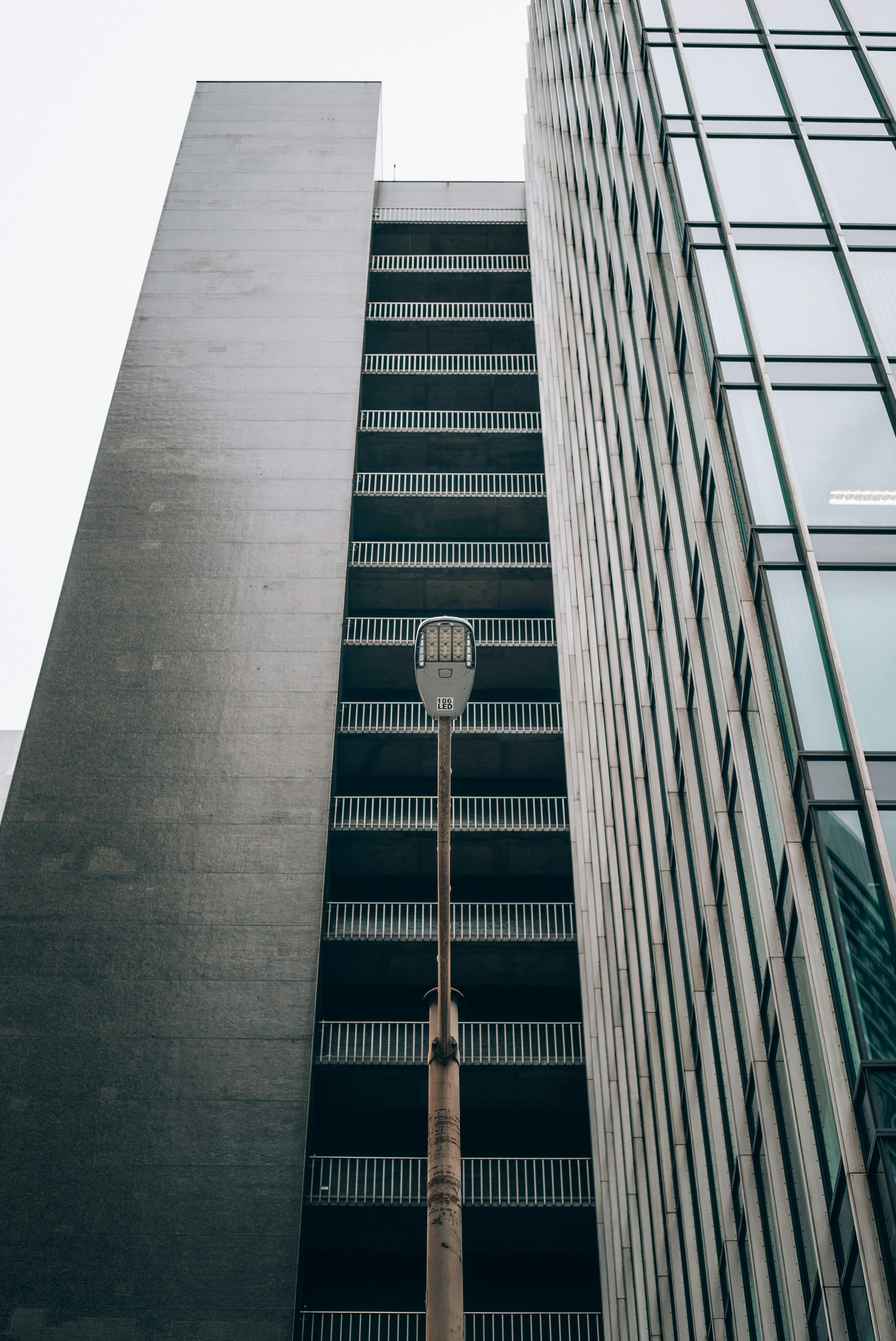 a street light is next to tall buildings