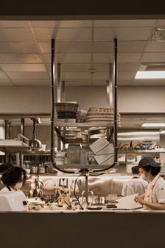 Chefs in a bustling restaurant kitchen preparing meals with precision and teamwork.